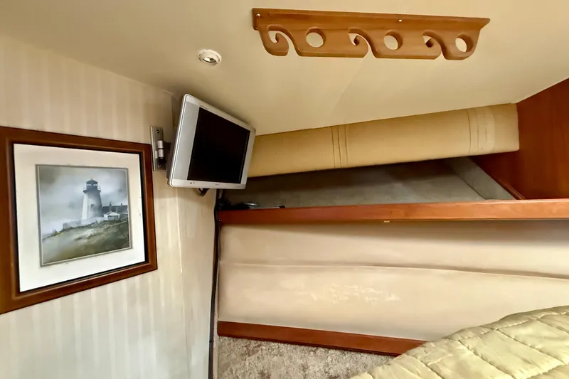 Slide: The Image of Interior of 1996 Egg Harbor 35 Sport Fisherman with TV and lighthouse artwork. - 35