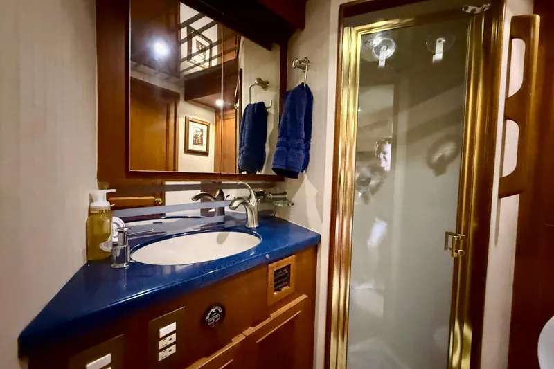 Slide: The Image of Luxurious bathroom in 1996 Egg Harbor 35 Sport Fisherman yacht with blue countertop and glass shower. - 37