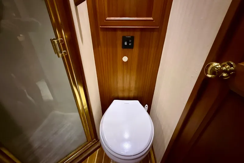 Slide: The Image of 1996 Egg Harbor 35 Sport Fisherman bathroom with wooden paneling and modern fixtures. - 38