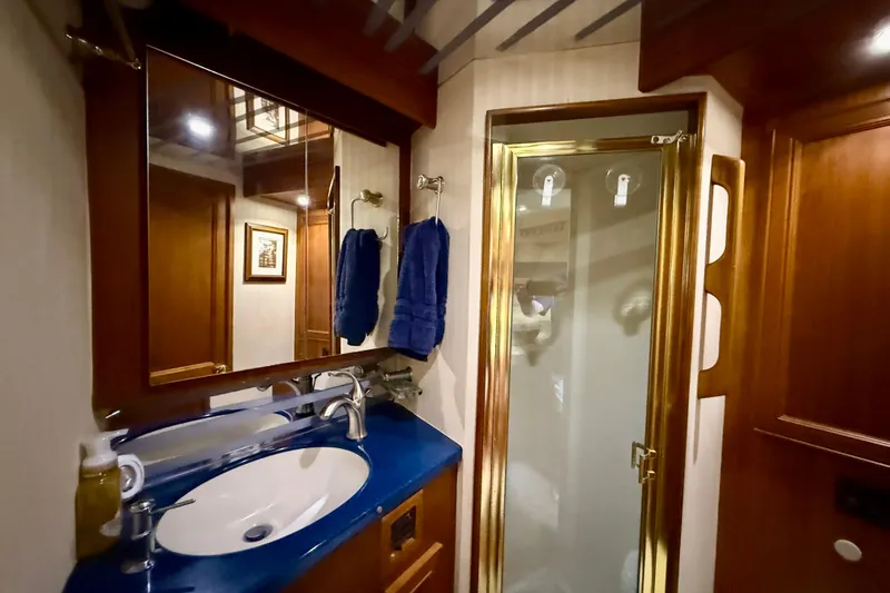 Slide: The Image of Bathroom interior of 1996 Egg Harbor 35 Sport Fisherman with blue countertop and shower. - 39