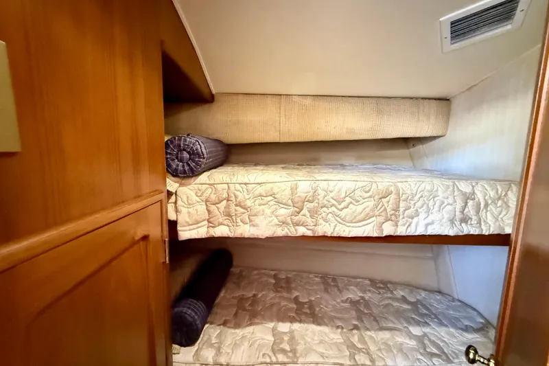 Slide: The Image of 1996 Egg Harbor 35 Sport Fisherman cabin with cozy bunk beds and wooden cabinetry. - 40