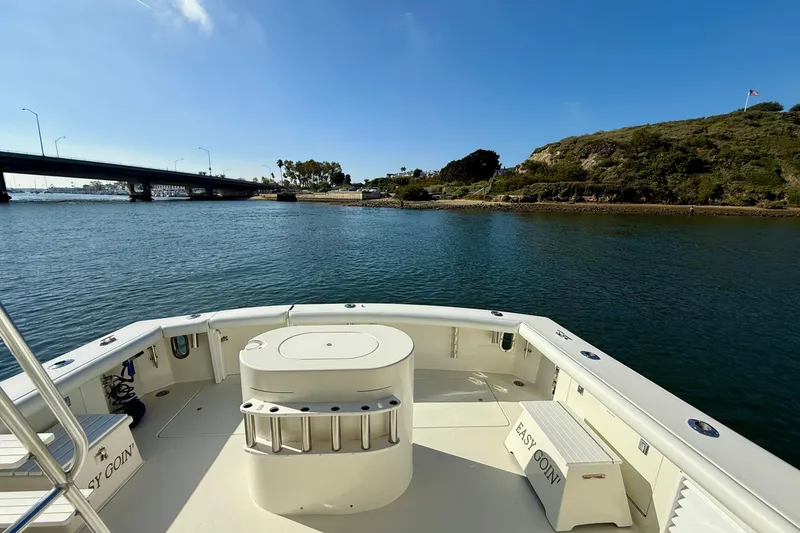 Slide: The Image of 1996 Egg Harbor 35 Sport Fisherman boat on calm water near a bridge and hillside. - 41