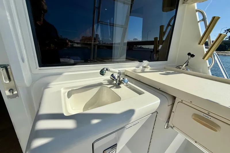 Slide: The Image of 1996 Egg Harbor 35 Sport Fisherman boat sink and counter area with ocean view. - 45