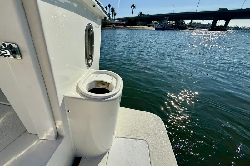Slide: The Image of 1996 Egg Harbor 35 Sport Fisherman boat, docked near a bridge, with sunny water reflections. - 46