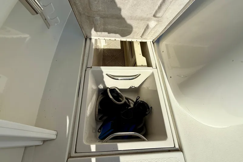 Slide: The Image of Storage compartment on 1996 Egg Harbor 35 Sport Fisherman with diving gear inside. - 53