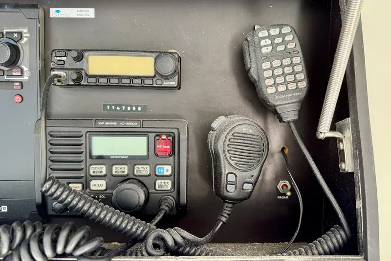 Slide: The Image of Control panel of a 1996 Egg Harbor 35 Sport Fisherman with communication devices. - 56