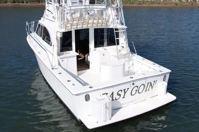 Slide: The Image of 1996 Egg Harbor 35 Sport Fisherman boat on water, rear view, named "Easy Goin'." - 6