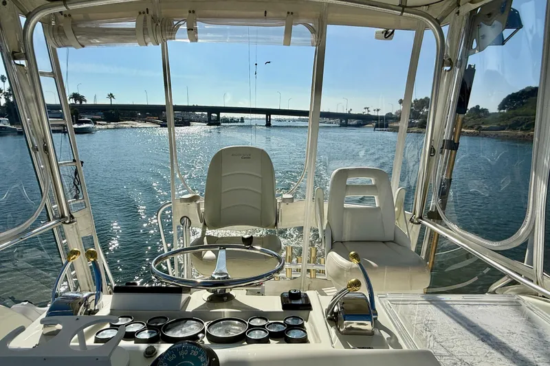 Slide: The Image of 1996 Egg Harbor 35 Sport Fisherman helm view, overlooking serene waterway and bridge. - 65