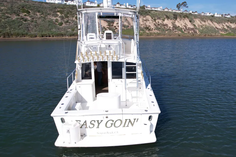 Slide: The Image of 1996 Egg Harbor 35 Sport Fisherman boat on water, Newport Beach backdrop. - 7