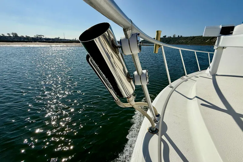 Slide: The Image of 1996 Egg Harbor 35 Sport Fisherman on water, featuring rod holder and sunny reflections. - 72