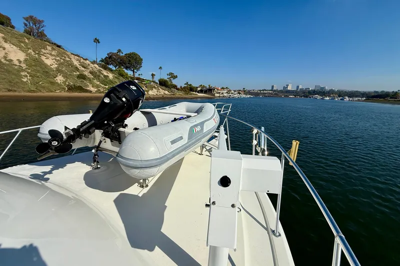 Slide: The Image of 1996 Egg Harbor 35 Sport Fisherman with inflatable boat on deck, scenic coastal view. - 73