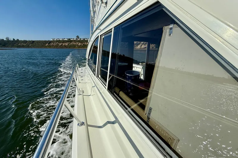 Slide: The Image of 1996 Egg Harbor 35 Sport Fisherman cruising on a sunny day near the coastline. - 74