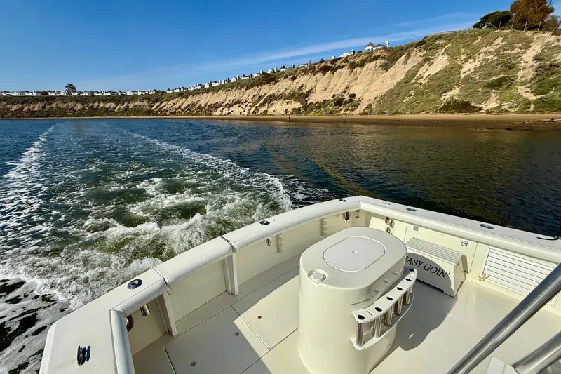 Slide: The Image of 1996 Egg Harbor 35 Sport Fisherman cruising along scenic coastal cliffs. - 75