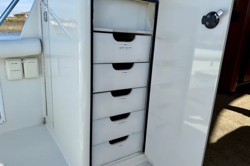 Slide: The Image of Storage drawers on a 1996 Egg Harbor 35 Sport Fisherman boat. - 76