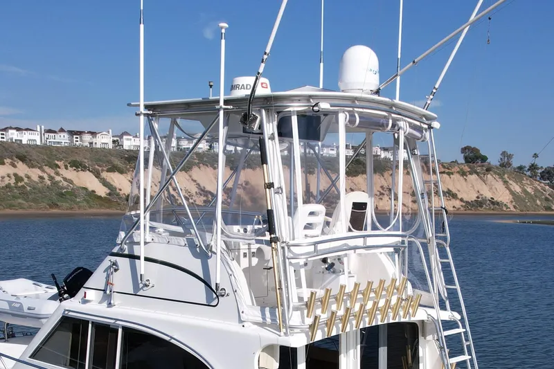 Slide: The Image of 1996 Egg Harbor 35 Sport Fisherman boat with fishing rods, coastal background. - 8