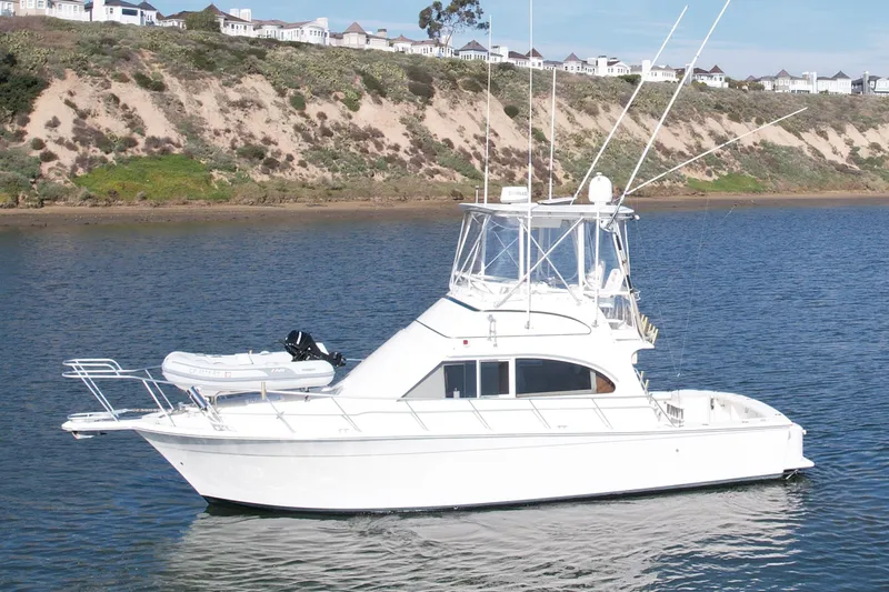 Slide: The Image of 1996 Egg Harbor 35 Sport Fisherman yacht on calm water near a scenic coastline. - 9