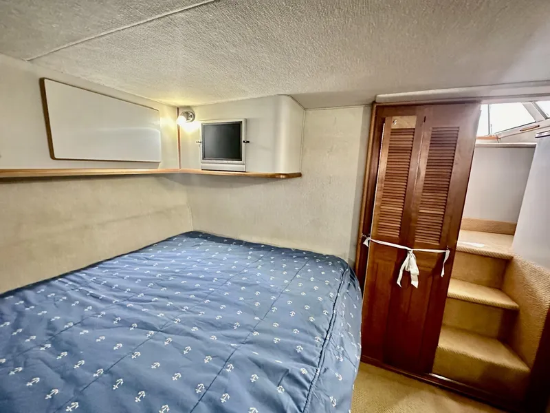 Slide: The Image of 1990 Sea Ray 380 Aft Cabin interior with bed and closet. - 13