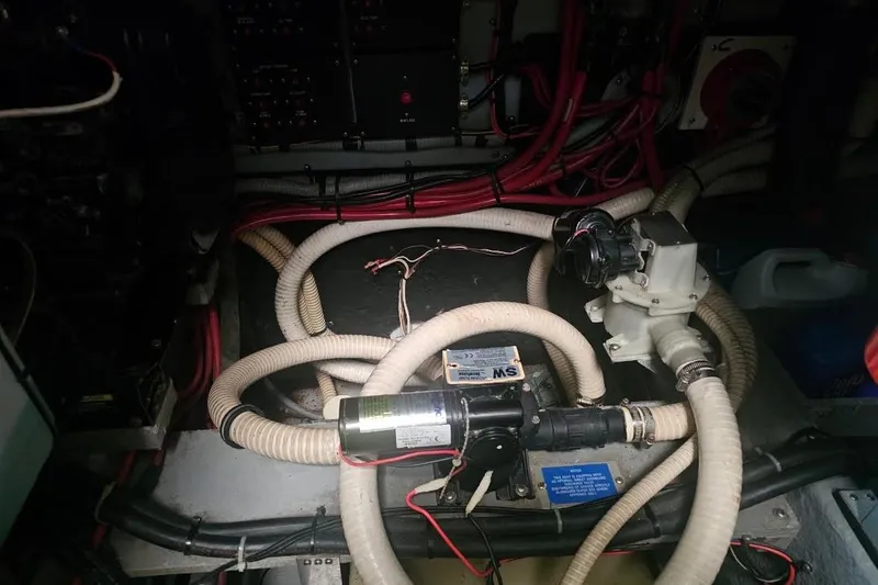 Slide: The Image of Engine room of 1990 Sea Ray 380 Aft Cabin with hoses and wiring. - 18