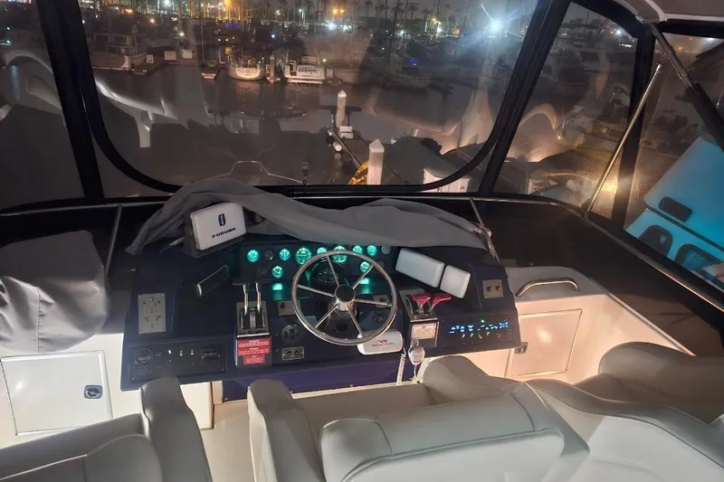 Slide: The Image of Cockpit of 1990 Sea Ray 380 Aft Cabin yacht at night, with illuminated controls. - 19