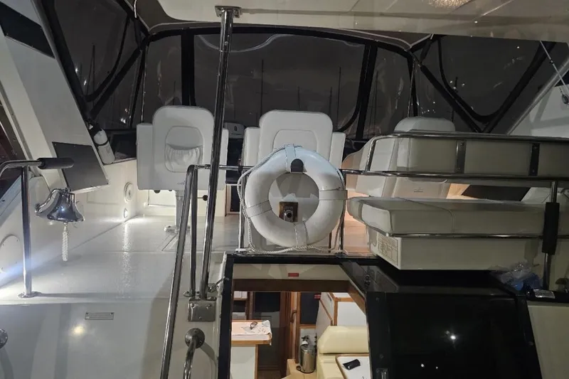 Slide: The Image of 1990 Sea Ray 380 Aft Cabin interior with seating and life preserver. - 20