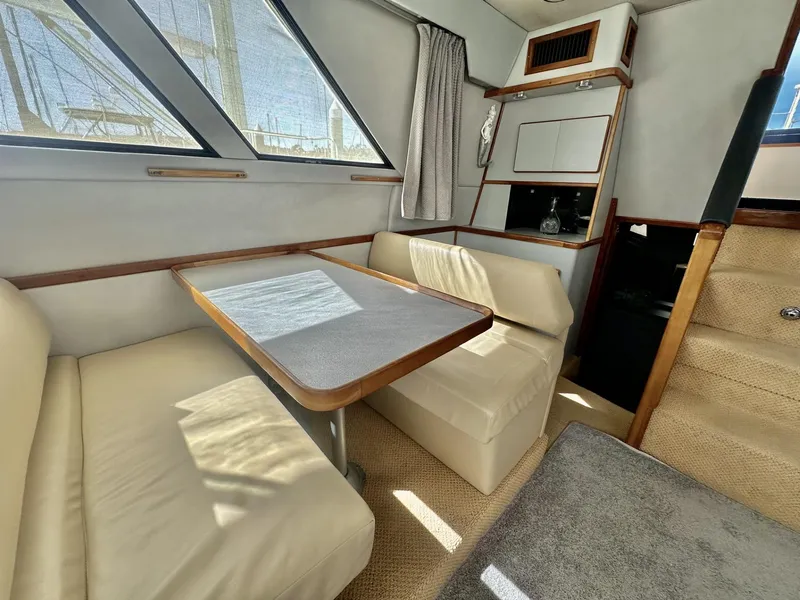Slide: The Image of 1990 Sea Ray 380 Aft Cabin interior with dining area. - 8