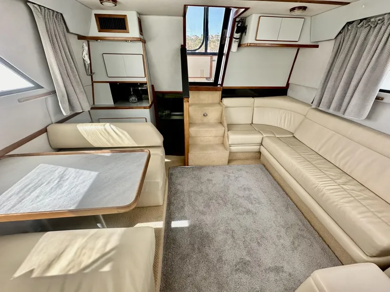 Slide: The Image of Interior of a 1990 Sea Ray 380 Aft Cabin yacht with beige leather sofas. - 9