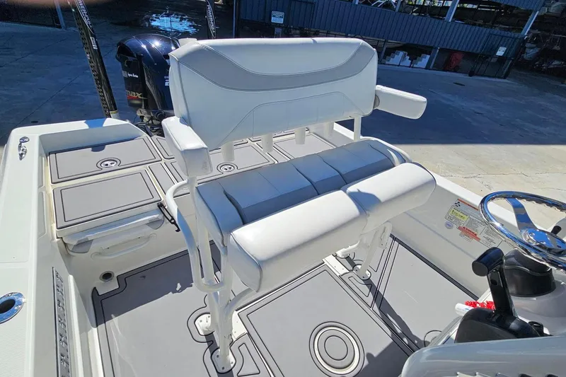Slide: The Image of 2021 Skeeter SX2250 boat interior with white seating and steering wheel. - 7