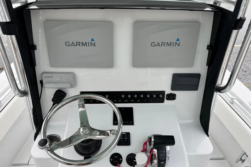 Slide: The Image of 2021 Contender 25 Tournament boat dashboard with Garmin navigation displays and controls. - 11