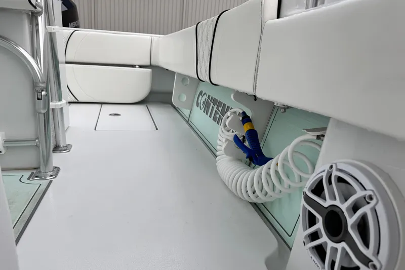 Slide: The Image of 2021 Contender 25 Tournament boat interior with seating, hose, and speaker. - 12