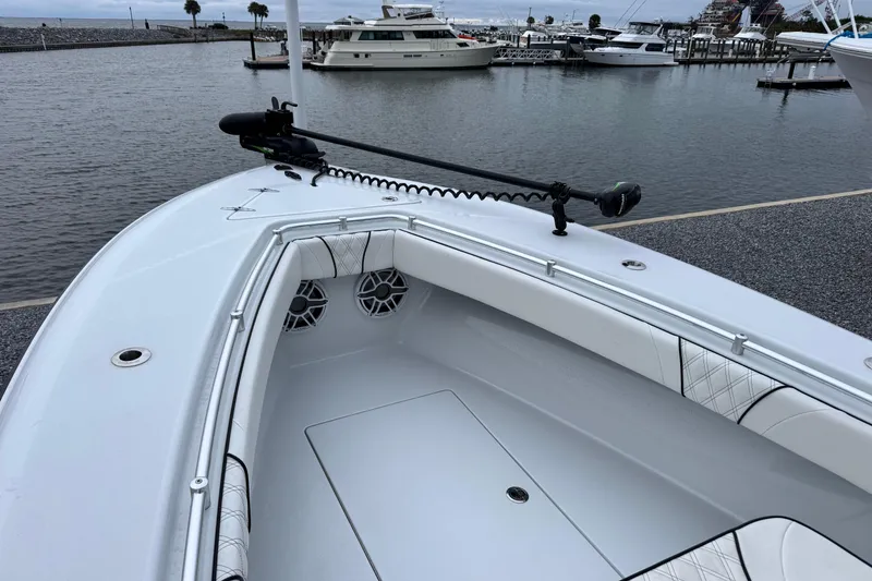 Slide: The Image of 2021 Contender 25 Tournament boat with sleek design, docked in a marina. - 4