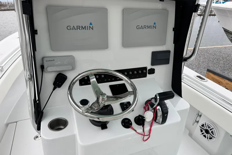 Slide: The Image of 2021 Contender 25 Tournament boat helm with Garmin navigation displays and steering wheel. - 9