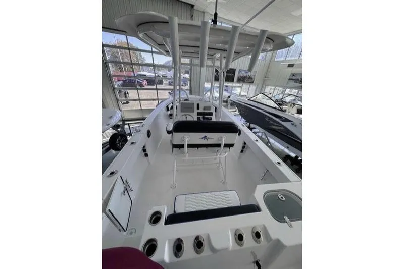 Slide: The Image of 2024 Aquasport 2200 Center Console boat interior with seating and console view. - 2