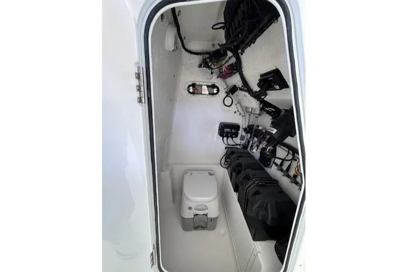Slide: The Image of 2024 Aquasport 2200 Center Console interior wiring and storage compartment. - 4