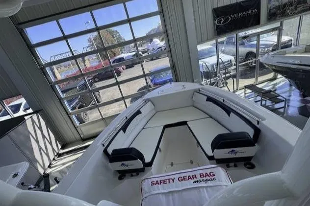 Slide: The Image of 2024 Aquasport 2200 Center Console boat interior in showroom with safety gear bag. - 6