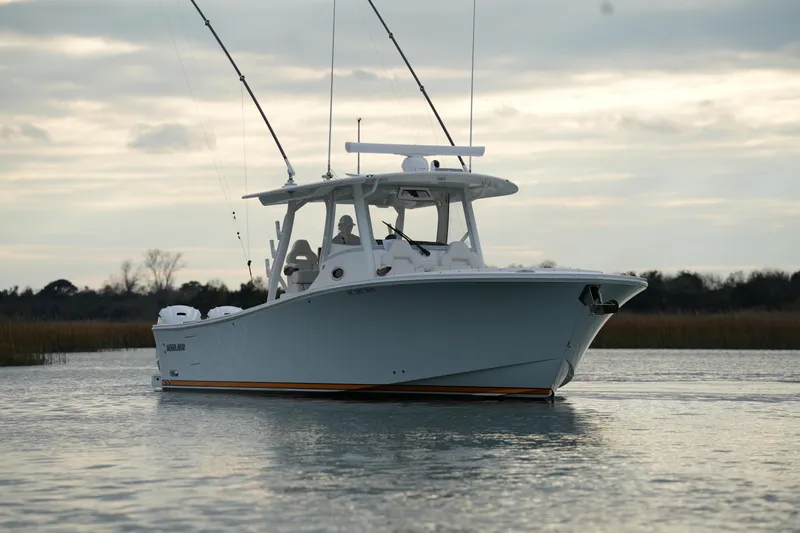 Slide: The Image of 2025 Regulator 37 boat on calm water under cloudy sky. - 14