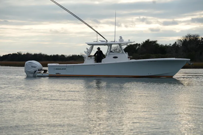Slide: The Image of 2025 Regulator 37 boat on calm water, overcast sky, side view. - 19