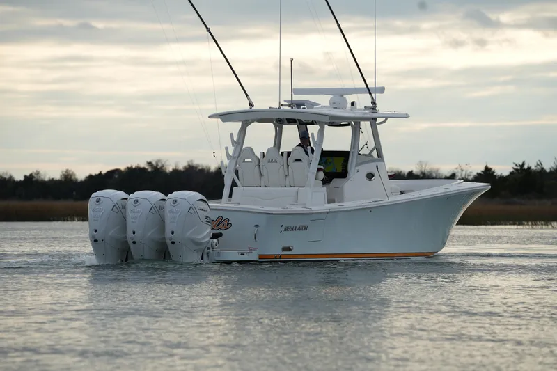 Slide: The Image of 2025 Regulator 37 boat with four engines cruising on calm water. - 22