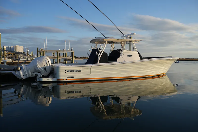 Slide: The Image of 2025 Regulator 37 boat docked on calm water under a clear sky. - 24