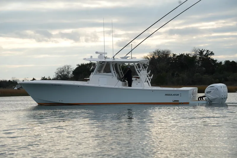 Slide: The Image of 2025 Regulator 37 boat on calm water, showcasing sleek design and powerful engine. - 3
