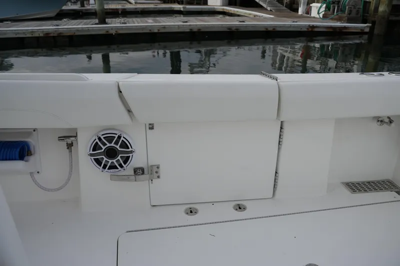 Slide: The Image of 2025 Regulator 37 boat interior with speaker and storage compartment at dock. - 31