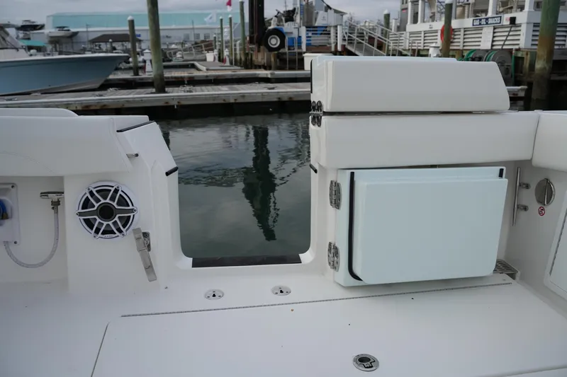 Slide: The Image of 2025 Regulator 37 boat interior with speaker and storage at marina. - 32