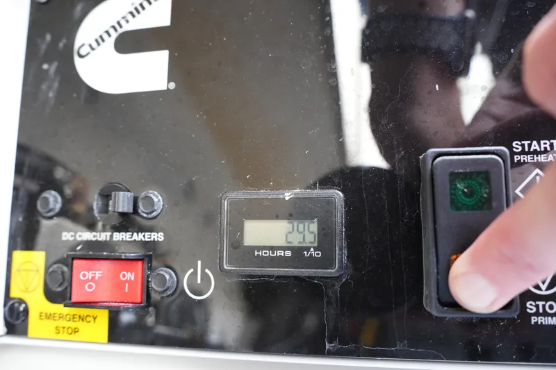 Slide: The Image of Control panel of a 2025 Regulator 37 boat with Cummins branding and hour meter. - 37