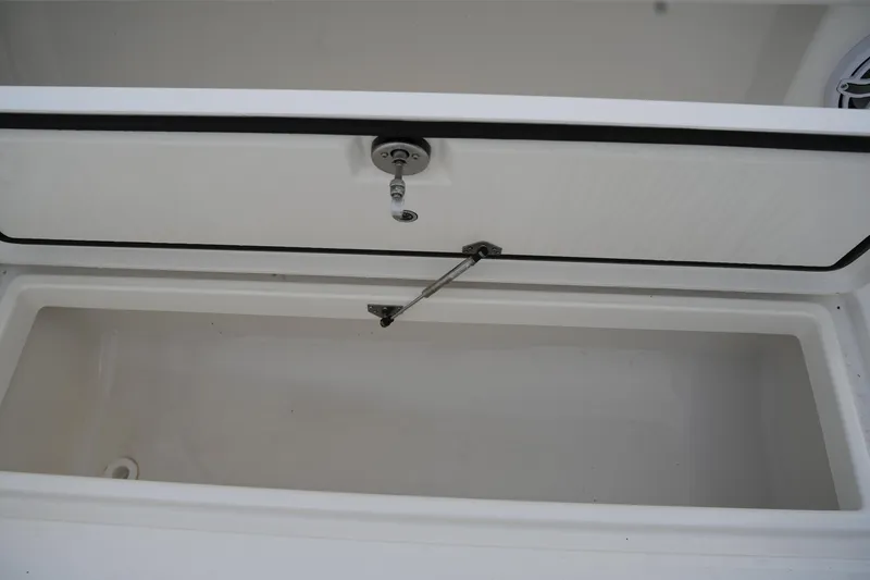 Slide: The Image of Open storage compartment on 2025 Regulator 37 boat, featuring a secure latch mechanism. - 39