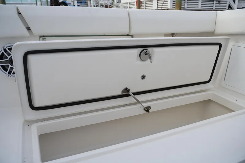 Slide: The Image of 2025 Regulator 37 boat storage compartment with open hatch and secure lock. - 40