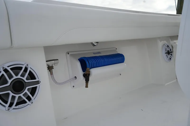 Slide: The Image of 2025 Regulator 37 boat interior with speakers and coiled blue hose. - 42