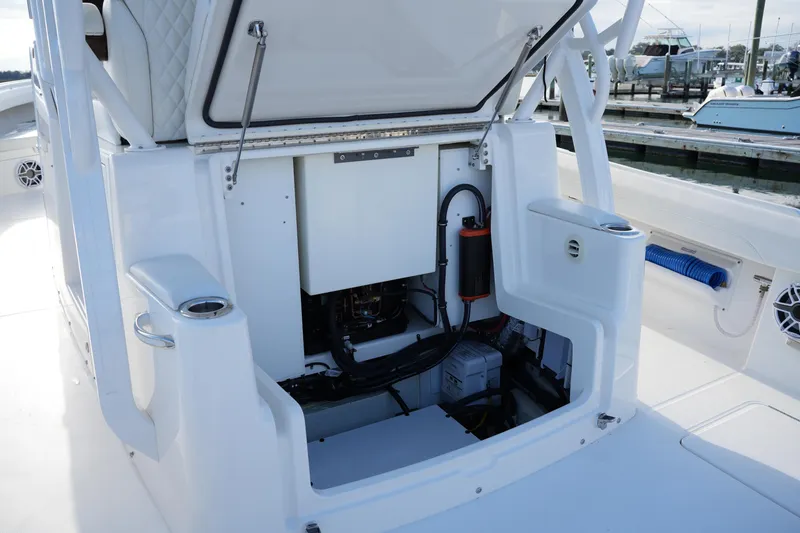 Slide: The Image of 2025 Regulator 37 boat interior with open storage compartment and visible equipment. - 44