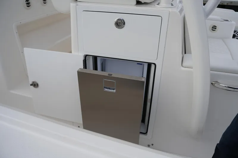Slide: The Image of 2025 Regulator 37 boat interior with open storage compartment and stainless steel drawer. - 49