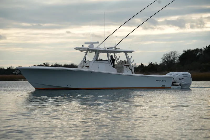Slide: The Image of 2025 Regulator 37 boat on calm water under cloudy sky. - 5
