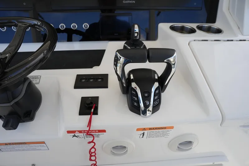 Slide: The Image of Control panel of 2025 Regulator 37 boat with steering wheel and throttle. - 58