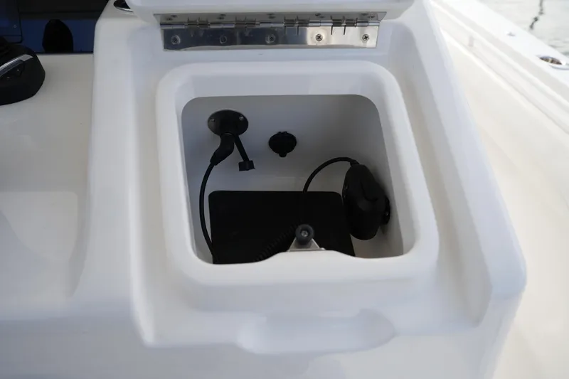 Slide: The Image of Storage compartment on 2025 Regulator 37 boat, featuring cables and connectors. - 59
